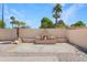 Inviting backyard featuring a fireplace, desert landscaping, and a paved patio area at 2663 N Carriage Ln, Chandler, AZ 85224