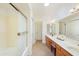 Bright bathroom with dual sink vanity and a shower and tub combination at 2663 N Carriage Ln, Chandler, AZ 85224