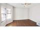 Well-lit bedroom features wood floors, neutral paint, and large window at 2663 N Carriage Ln, Chandler, AZ 85224