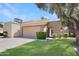 Charming single-story home featuring a well-manicured lawn, mature trees, and a tile roof at 2663 N Carriage Ln, Chandler, AZ 85224