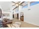 Open-concept living room with vaulted ceilings, a fireplace, and tile flooring at 2663 N Carriage Ln, Chandler, AZ 85224
