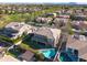 Beautiful aerial view of a home and surrounding neighborhood featuring lush greenery and a swimming pool at 2988 E Comstock Dr, Gilbert, AZ 85296