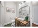 Bathroom featuring a walk-in shower, mirror, and sink with eclectic vanity at 2988 E Comstock Dr, Gilbert, AZ 85296
