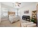 Bedroom featuring a bed with accent pillows, a piano, and a ceiling fan at 2988 E Comstock Dr, Gilbert, AZ 85296