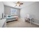 Cozy bedroom featuring a ceiling fan, a bright window, and a charming white desk at 2988 E Comstock Dr, Gilbert, AZ 85296