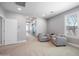 Bright bedroom features neutral walls, carpet, large window and two upholstered chairs at 2988 E Comstock Dr, Gilbert, AZ 85296