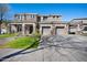 Elegant two-story house with stone accents, three-car garage, and well-maintained lawn, displaying curb appeal at 2988 E Comstock Dr, Gilbert, AZ 85296