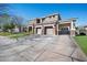 Spacious two-story house with stone accents, three-car garage, and wide driveway, perfect for a growing Gathering at 2988 E Comstock Dr, Gilbert, AZ 85296