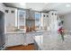 Kitchen featuring white cabinets, granite counters, stainless appliances, and tiled backsplash at 2988 E Comstock Dr, Gilbert, AZ 85296