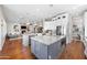 Open kitchen with granite counters, stainless appliances, white cabinets, and view to living area at 2988 E Comstock Dr, Gilbert, AZ 85296