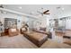 Bright living room with neutral color palette, ceiling fan, and cozy seating area at 2988 E Comstock Dr, Gilbert, AZ 85296