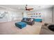 Spacious living room with neutral carpet, a ceiling fan, and comfortable seating at 2988 E Comstock Dr, Gilbert, AZ 85296