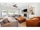 Cozy living room with a fireplace, large sectional sofa, and natural light, perfect for relaxation at 2988 E Comstock Dr, Gilbert, AZ 85296