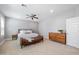 Comfortable main bedroom features a ceiling fan, a large bed, and a leather bench at 2988 E Comstock Dr, Gilbert, AZ 85296