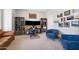 Well-lit office with modern desk setup, blue chairs, and ample shelving, creating a productive workspace at 2988 E Comstock Dr, Gilbert, AZ 85296