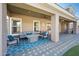 Covered patio with comfortable seating, a fire pit, ceiling fans, and brick pavers at 2988 E Comstock Dr, Gilbert, AZ 85296