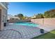 Backyard with a sparkling in-ground swimming pool and decorative brick pavers at 2988 E Comstock Dr, Gilbert, AZ 85296