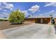Charming brick home with a long driveway, solar panels, and a well-kept yard at 3002 E Montecito Ave, Phoenix, AZ 85016