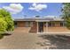 Charming brick home featuring a well-kept yard, solar panels, and a welcoming front entrance at 3002 E Montecito Ave, Phoenix, AZ 85016