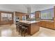 Spacious kitchen featuring wooden cabinets, a granite island with seating, and modern stainless steel appliances at 3002 E Montecito Ave, Phoenix, AZ 85016