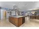 Open floor plan featuring a kitchen island with cooktop and access to living and dining areas at 3002 E Montecito Ave, Phoenix, AZ 85016
