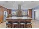 Bright kitchen featuring wooden cabinets, granite countertops, an island with seating, and stainless appliances at 3002 E Montecito Ave, Phoenix, AZ 85016
