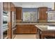 Updated kitchen with stainless steel appliances, granite countertops and warm wood cabinetry at 3002 E Montecito Ave, Phoenix, AZ 85016