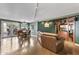 Bright living room with large leather couch, hardwood floors, dining table and chairs, and media center at 3002 E Montecito Ave, Phoenix, AZ 85016