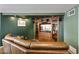 A large leather couch is positioned in front of a wood cabinet, creating a cozy and inviting atmosphere at 3002 E Montecito Ave, Phoenix, AZ 85016
