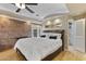 Inviting bedroom featuring a brick accent wall, recessed lighting, and private access to the backyard at 3002 E Montecito Ave, Phoenix, AZ 85016