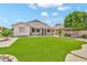 Expansive backyard with well-maintained artificial grass, patio, and pergola, ideal for relaxation and gatherings at 3044 E Sparrow Pl, Chandler, AZ 85286
