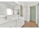Bathroom with double sinks, a large mirror, and built-in storage cabinets at 3044 E Sparrow Pl, Chandler, AZ 85286