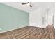 Neutral bedroom featuring wood flooring, a ceiling fan, and natural light at 3044 E Sparrow Pl, Chandler, AZ 85286
