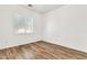Bright bedroom featuring wood-look floors, white walls, a large window, and recessed lighting at 3044 E Sparrow Pl, Chandler, AZ 85286