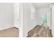 Hallway with wood and tile floors, white walls, and a view of a bathroom at 3044 E Sparrow Pl, Chandler, AZ 85286