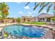 Inviting backyard oasis featuring a sparkling pool, lush landscaping, and a relaxing patio area at 3044 E Sparrow Pl, Chandler, AZ 85286