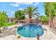 Private backyard pool with a charming rock waterfall feature and meticulously manicured landscaping at 3044 E Sparrow Pl, Chandler, AZ 85286