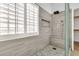 Tiled walk-in shower with a built-in bench, rain shower head, and a window allowing natural light at 3044 E Sparrow Pl, Chandler, AZ 85286