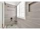 Tiled walk-in shower featuring a built-in niche, hand shower, and rain shower head at 3044 E Sparrow Pl, Chandler, AZ 85286