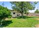 Lush backyard with green lawn, shade trees, and an inviting covered patio at 3115 N 34Th Pl, Phoenix, AZ 85018