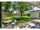 Serene backyard with a lush lawn, mature trees, a hammock, and an inviting outdoor dining area at 3115 N 34Th Pl, Phoenix, AZ 85018