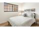 Cozy bedroom featuring hardwood floors, a decorative throw pillow, and charming wall art at 3115 N 34Th Pl, Phoenix, AZ 85018