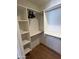 Organized closet with shelves, rods, and hardwood floors at 3115 N 34Th Pl, Phoenix, AZ 85018