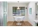 Eat-in kitchen features a modern white table and chairs set beneath a stylish pendant light at 3115 N 34Th Pl, Phoenix, AZ 85018