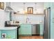Updated kitchen features stainless steel appliances, light green cabinets, and white countertops at 3115 N 34Th Pl, Phoenix, AZ 85018