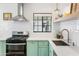 Updated kitchen featuring subway tile backsplash, stainless steel appliances, and eye-catching aqua cabinetry at 3115 N 34Th Pl, Phoenix, AZ 85018
