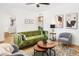 Beautiful living room featuring a green sofa, art, and wood-look floors at 3115 N 34Th Pl, Phoenix, AZ 85018