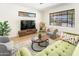 Inviting living room with wood-look floors, large windows, modern furniture, and neutral colors at 3115 N 34Th Pl, Phoenix, AZ 85018