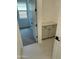Hallway with tiled flooring, built in cabinets, and access to a bedroom with carpet at 31274 N 130Th Ave, Peoria, AZ 85383