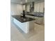 Contemporary kitchen featuring a large island with granite countertop, stainless steel appliances and white cabinets at 31274 N 130Th Ave, Peoria, AZ 85383